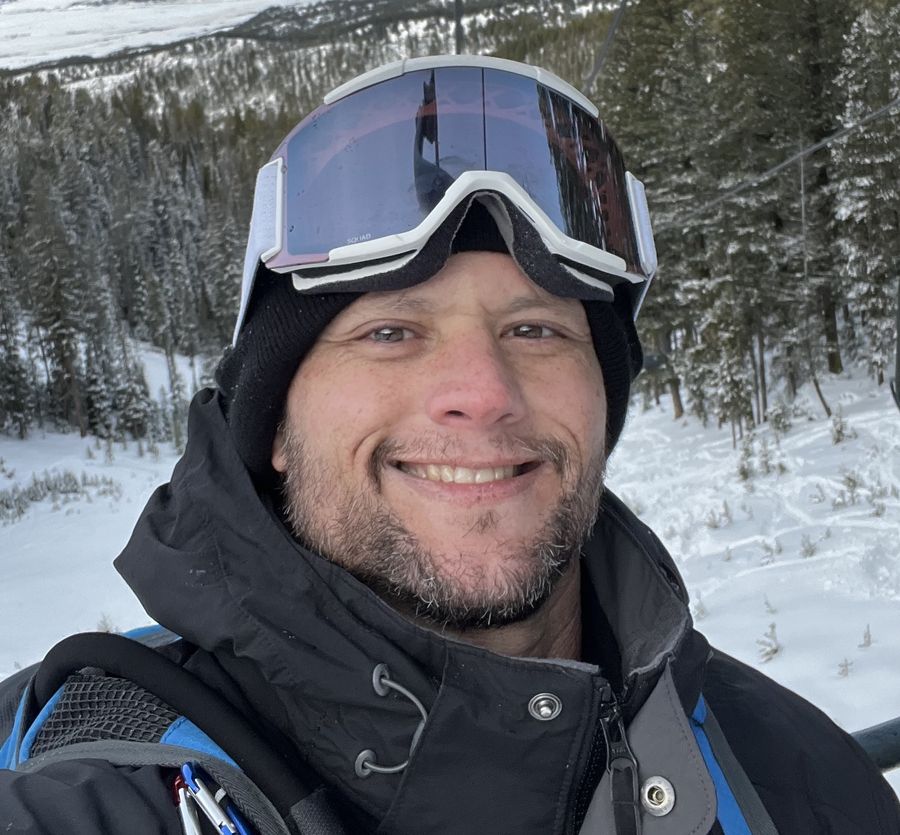 Chad Binkley smiling in a snowy mountain landscape